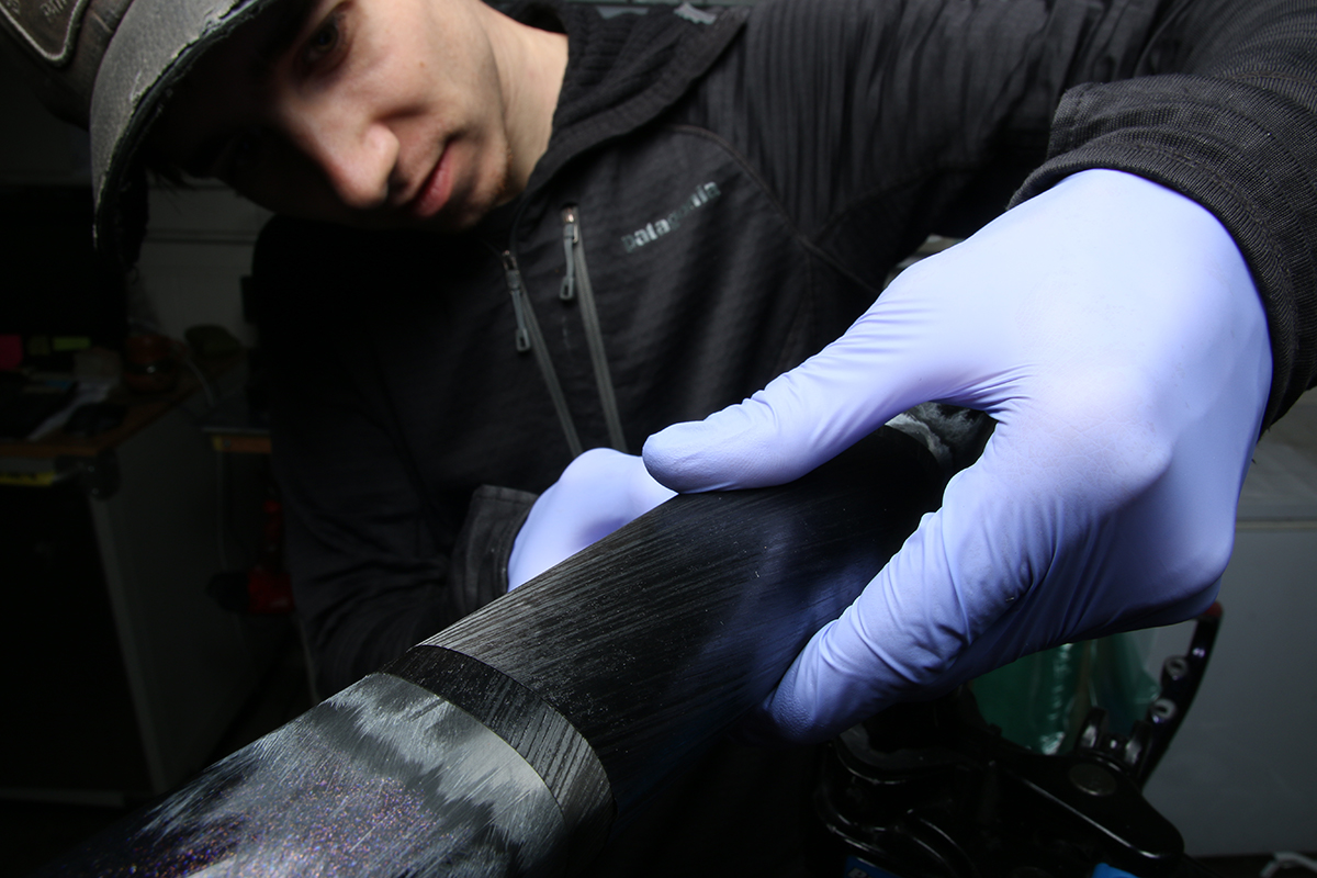 Ruckus composites repair technician repairing a carbon trek road bike top tube